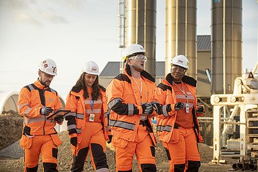 Four workers on a construction site for tunnelling