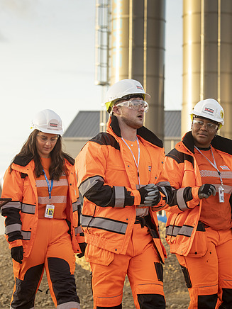 Four workers on a construction site for tunnelling