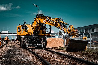 An excavator in use on rails