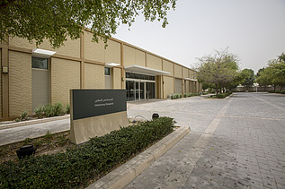 Entrance area of the Al Shaqab Equine Veterinary Medical Centre, featuring the veterinary facility building, access road, and clinic signage