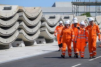 Several workers in front of prefabricated concrete components