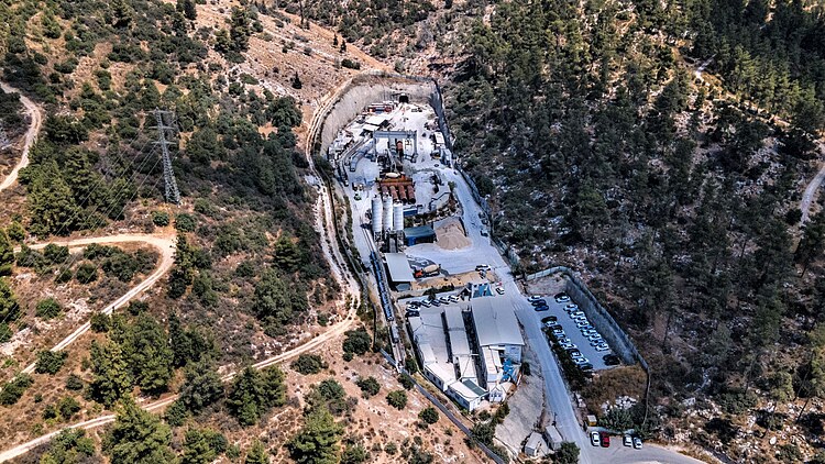 Aerial view of a tunnel construction site for the water supply pipeline to Jerusalem in a forested mountainous area