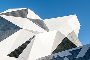 Crystal-Shaped building of the Sky Venture facility on Yas Island, featuring a white facade and large glass surfaces