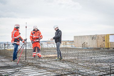 Three workers on a building construction