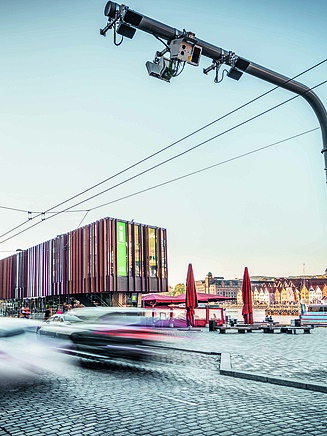 A traffic light system with cars passing by