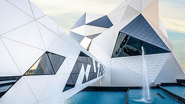 Crystal-Shaped building of the Sky Venture facility on Yas Island, featuring a white facade and large glass surfaces