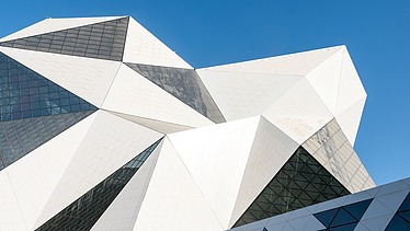 Crystal-Shaped building of the Sky Venture facility on Yas Island, featuring a white facade and large glass surfaces