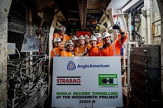 Several tunnel workers with a large banner