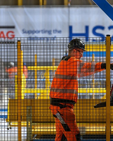 A construction worker behind a grille