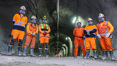 Employees wearing personal protective equipment inside an underground tunnel at Chuquicamata Mine in Chile