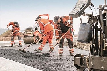 Image of workers and machines in road construction