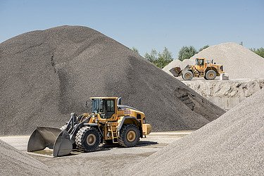 Excavator in building materials pit